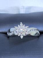Lady's Diamond Cluster Ring: 3.3g 10k-W/G, 1-Round Brilliant Cut Diamond 0.06ctw, 26-Round Brilliant